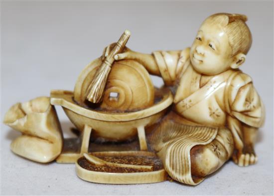 A Japanese ivory netsuke of a boy grinding seed?, Meiji period, 5.1cm